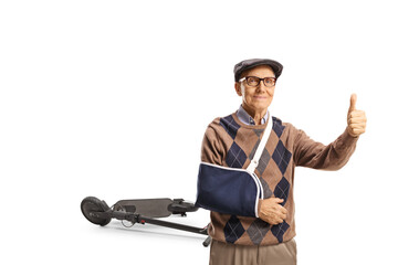 Elderly man with a broken arm gesturing thumbs up isolated on white background