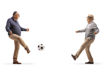 Two mature men kicking football