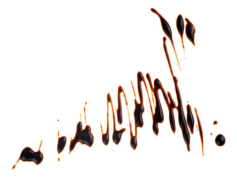Splashes of sweet chocolate syrup isolated on a white background, top view. Melted chocolate sauce.