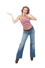 Joyful young woman who is listening to music through red headphones, dancing and looks to the side with her blue eyes while being isolated against a white background