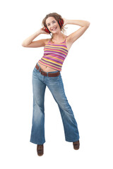 Joyful young woman who is listening to music through red headphones, dancing and looking at camera with her blue eyes while being isolated against a white background