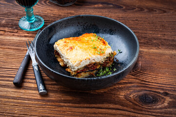 Traditional Greek moussaka with beef mince, eggplant and bechamel sauce served as close-up in a...