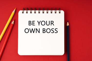 Be your own boss text on notepad red background