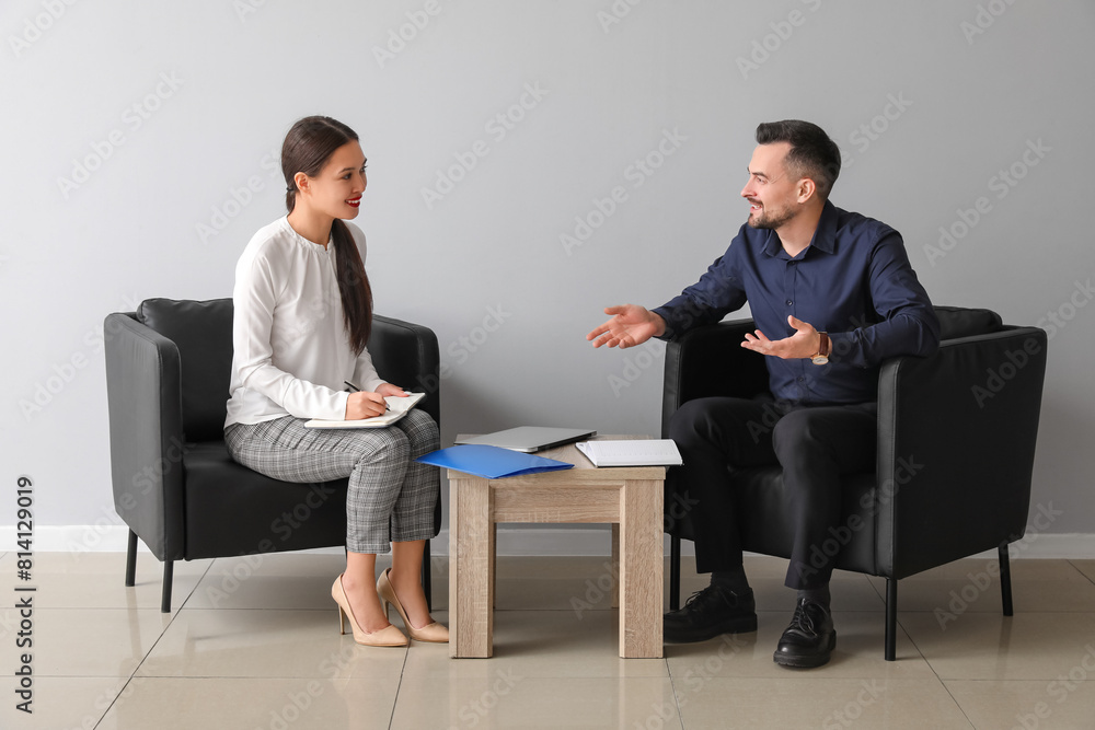 Wall mural Human resources manager interviewing applicant near light wall in office