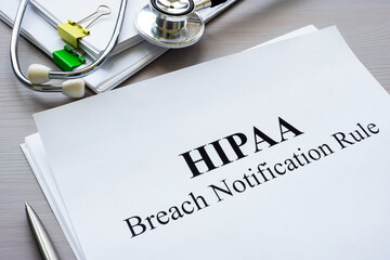 Documents HIPAA breach notification rule on the table.