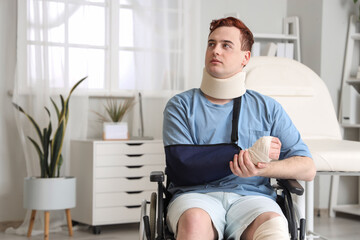 Injured young man after accident in wheelchair at hospital