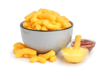 Bowl with tasty corn sticks and sauces on white background