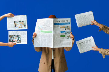 Woman with hands holding newspapers on blue background