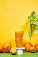 cup of orange and peaches juices with fresh fruits