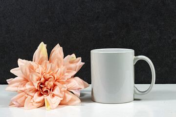 white coffee mug , white porcelain mug mock up with pink dahlia flower on white wood table