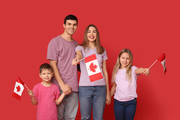 Happy family with flags of Canada on red background