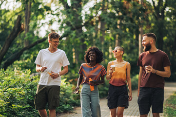 Happy multicultural friends enjoying walk and having fun together.