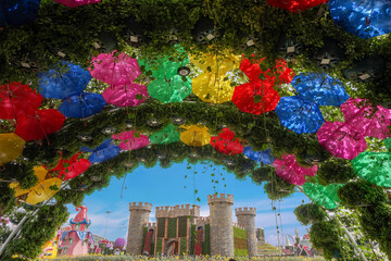 bright floral und umbrella arch with a flower castle in the Miracle Garden in Dubai