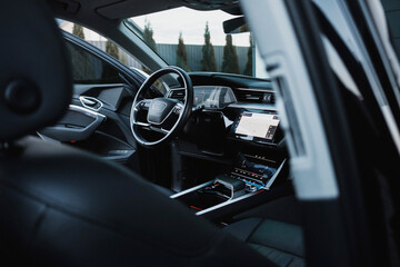 Modern black subcompact electric crossover SUV with black interior. Details interior.