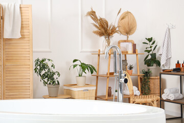 White bathtub in light bathroom