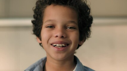 Close up portrait little boy African American ethnic child son male baby pupil schoolboy school kid junior orphan toddler cute face smiling laughing at home cheerful carefree children custody adoption
