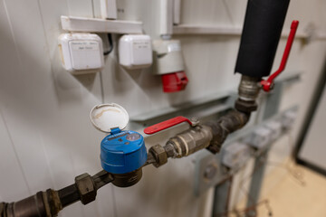 A small blue water meter with a pipe cap.