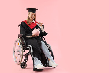 Female graduate in wheelchair putting money into piggy bank on pink background