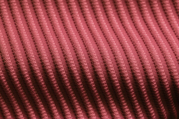 Closeup of pink orange corduroy cloth as patterned textured background