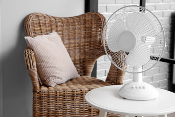 Modern electric fan on coffee table at home