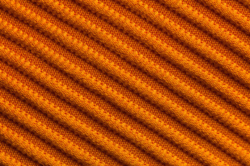 Closeup of orange corduroy cloth as patterned textured background