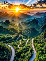 Scenic view of winding road in the mountains with the sun shining through the clouds.