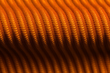 Closeup of orange corduroy cloth as patterned textured background