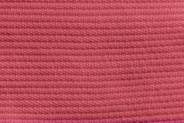 Closeup of pink orange corduroy cloth as patterned textured background