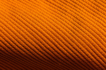 Closeup of orange corduroy cloth as patterned textured background