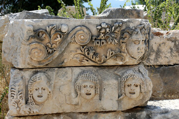 Stone faces bas relief at Myra ancient city. Demre, Turkey masks and Lycian tombs in the Myra, Turkey historical site