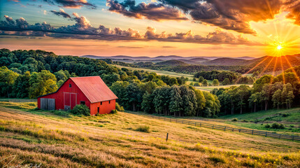 Red barn in the middle of field with sunset in the background.