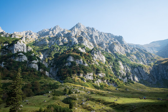 a wide shoot of light shining on green mountains