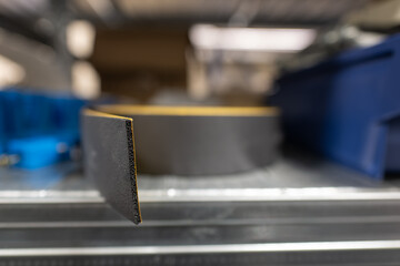 Adhesive insulating tape black in the shelf.