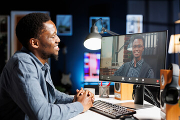 Job recruiter asking questions at online interview on videocall, meeting with young applicant on remote telework conference. Management staff having discussion with african american person.