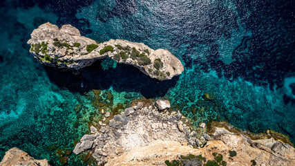 The coast of Cala D'or in South of Mallorca Spain in summer time on a sunny day with blue water and rocks