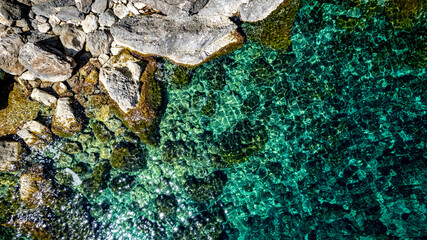 The coast of Cala D'or in South of Mallorca Spain in summer time on a sunny day with blue water and rocks