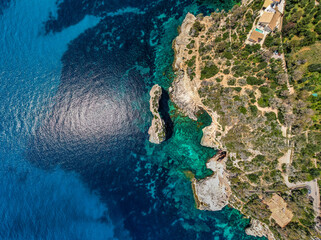 The coast of Cala D'or in South of Mallorca Spain in summer time on a sunny day with blue water and...