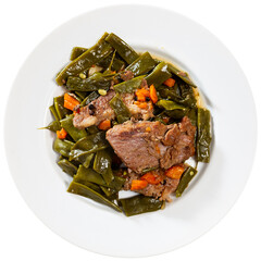 There is plate with braised beef fillet and stewed vegetable. Stewed string beans with carrot...