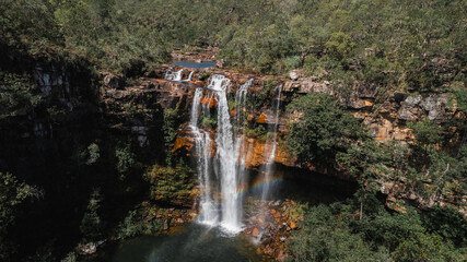 Aerial view Cordovil waterfall in Chapada dos Veadeiros, Goiás, Brazil, green water well, sunny day, beautiful waterfall, rainbow