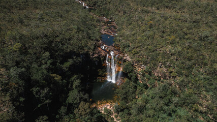 Aerial view Cordovil waterfall in Chapada dos Veadeiros, Goiás, Brazil, green water well, sunny day, beautiful waterfall, rainbow
