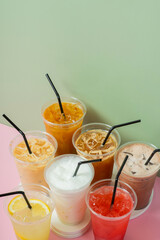 Colourful summer drinks with ice. Lemonade and coctails on colored background