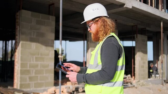 Building planning with tablet on construction site in worker engineer man hands, communication, maintenance and renovation, using technology.
