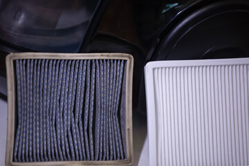 New and old white square dust filter for vacuum cleaner. Replacing a vacuum cleaner filter. Close-up.