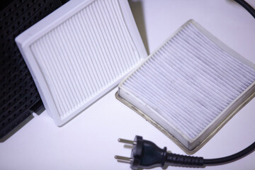 New and old white square dust filter for vacuum cleaner. Replacing a vacuum cleaner filter. Close-up.