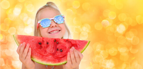 close-up of happy cool trendy funky hipster blonde girl in sunglasses eating ripe red watermelon,...
