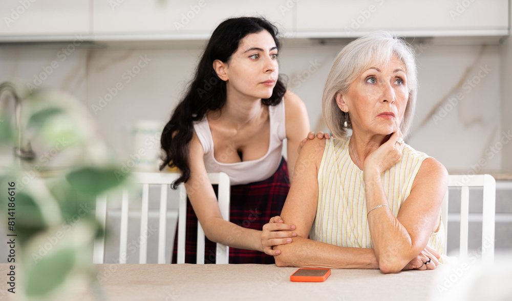 Wall mural adult daughter apologizes to her elderly mother after a domestic quarrel