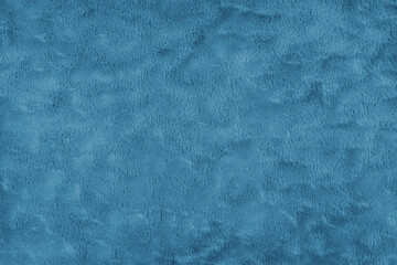 Texture of fluffy blue upholstery fabric or cloth. Fabric texture of artificial fur textile material. Canvas background. Decorative fabric for curtain, furniture, walls, clothes.