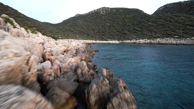 fast flight over coastal cliffs washed by the Mediterranean Sea with clear azure water. High quality 4k footage drone shoot
