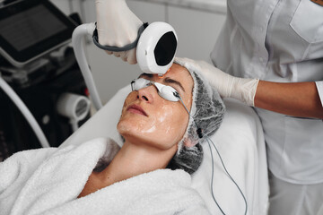 A woman receives IPL therapy in a beauty salon.