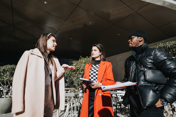 Multiracial group of people in a casual meeting outside their office, engaging in a discussion with a sense of teamwork.